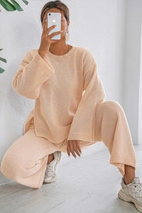 Detail of soft warm apricot knitted loungewear set featuring fine ribbed fabric texture