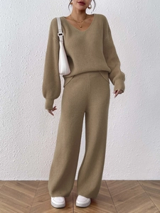 Close-up of V-neck knitted sweater and wide-leg pants set in soft khaki fabric