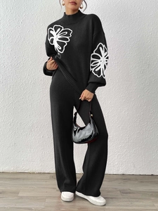 Women black knit sweater set with white floral embroidery and wide leg trousers