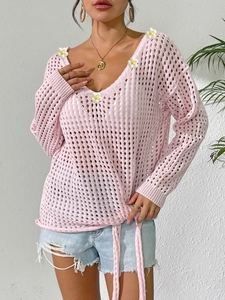 Detailed pink crochet knit top featuring delicate white daisy appliques and hollow weave