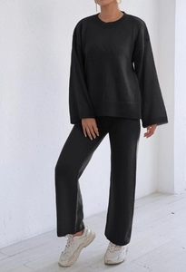 Detail of black knit lounge set with ribbed crewneck top and wide-leg trousers