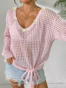 Detail of pink hollow-out crochet V-neck top with white 3D daisy flowers and tie hem
