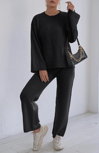 Detail of black knit loungewear set with crewneck sweater and wide-leg trousers
