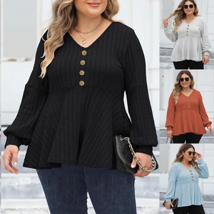 Close-up of V-neck ribbed long sleeve top with golden buttons and peplum hem detail
