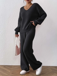Detail of V-neck knit sweater and wide-leg trousers set with fine texture and drape