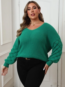 Close-up of bright green V-neck sweater featuring textured bubble sleeves and knit detail