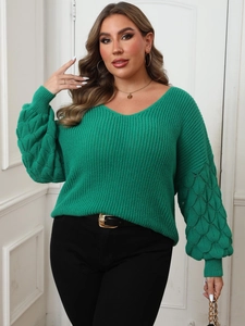 Detail of green plus size knit sweater featuring textured lantern sleeves and deep V-neck