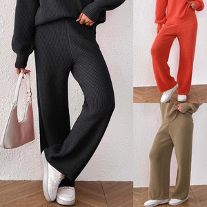 Detail view of knitted two-piece set showing black, orange, and khaki green color options