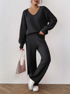 Close-up of dark grey V-neck knit sweater set with detailed vertical ribbed texture