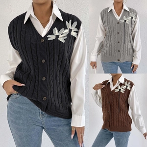 Detailed close-up of retro V-neck knit vest featuring 3D floral patches and button closure