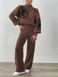 Close-up of brown knit set showing floral embroidery on sweater and wide leg pants