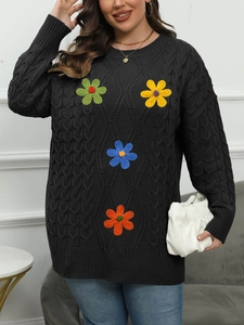 Women's black knit sweater with colorful embroidered flowers and round neckline