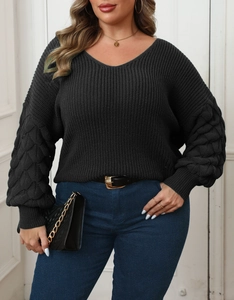Detail of grey V-neck knit sweater with textured pineapple sleeves and woven patterns
