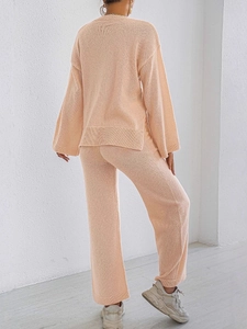 Women's two-piece knit lounge set with oversized sweater and wide-leg trousers in apricot pink