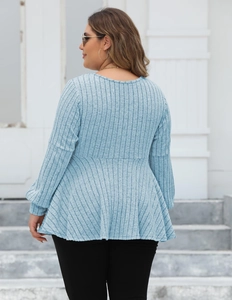 Detail of light blue plus size ribbed knit top showing peplum waist and texture