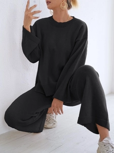 Women's black knit lounge set featuring a long sleeve sweater and wide-leg trousers