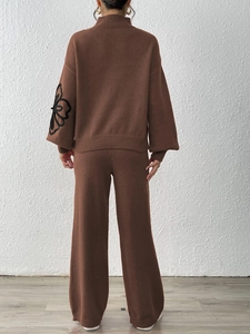 Dark brown knit set with turtleneck sweater featuring floral embroidery and wide-leg pants