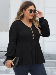 Close-up of V-neck ribbed knit top with vintage gold textured buttons and peplum waist