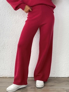 Women's red knit matching set with high waist wide leg trousers and long sleeve top