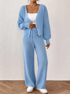 Detail of light blue knit set featuring buttoned cardigan and drawstring wide-leg pants