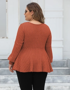 Back view of a plus size ribbed knit tunic with peplum hem in rust red color