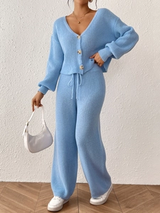Detail view of sky blue knit cardigan with buttons and matching drawstring wide-leg pants