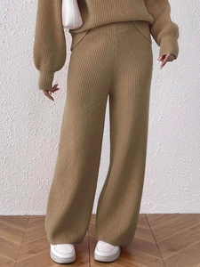 Detail of camel high waist wide-leg knitted trousers with vertical ribbed texture