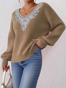 Detail of V-neck knit sweater with silver sequined feather pattern on khaki fabric