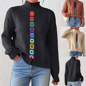 Detail of colorful crochet flower embroidery on a mock neck knitted long sleeve sweater