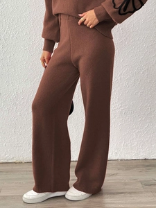 Close-up of deep brown knitted two-piece set featuring wide-leg trousers and long sleeves