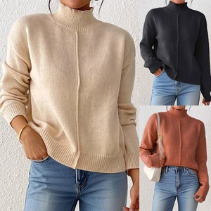 Detailed knit texture of women's mock neck sweater in beige, black and brick red colors