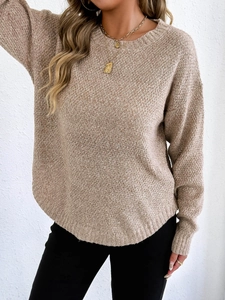 Detail of beige marl knit sweater showing ribbed crew neck and textured heathered fabric
