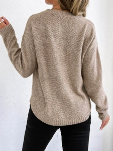 Rear view of a beige knit sweater for women showing the thick textured fabric and curved hemline