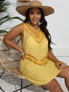 Detail of yellow beach cover-up featuring intricate crochet cut-outs and V-neckline