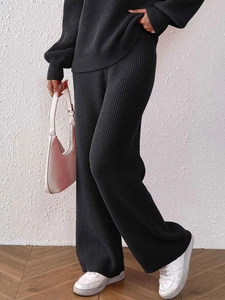 Women's two-piece black ribbed knit set with wide-leg pants and loose long sleeve top
