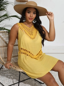 Close-up of vibrant yellow crochet hollow-out detailing on a sleeveless beach cover-up dress