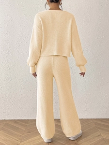 Close-up of the cream knit set featuring a ribbed texture cardigan and wide-leg trousers
