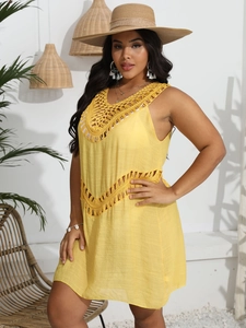 Close-up of bright yellow beach cover-up featuring intricate crochet neckline details