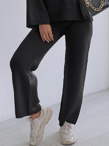 Women's chic black knit two-piece set featuring high-waist wide-leg trousers and loose top
