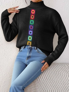 Women's black high neck knit sweater with colorful crochet floral patchwork design