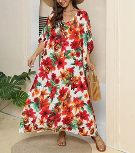 Detail of bohemian V-neck floral maxi dress with vibrant print and loose batwing sleeves