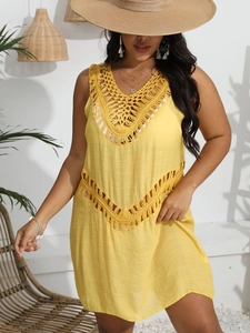 Close-up of bright yellow crochet detailing and hollow-out fabric on beach dress