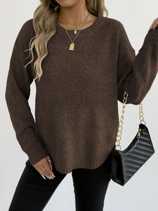 Detailed knit texture of dark brown crew neck sweater with elegant jewelry styling