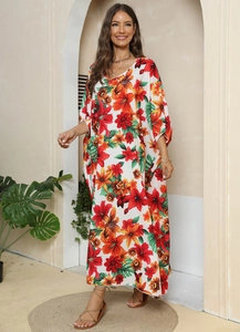 Detail of V-neck floral maxi dress featuring wide half-sleeves and vibrant lily print