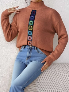 Detail of colorful crochet floral stripe on caramel mock neck knit sweater