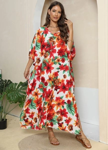 Detail of floral printed kaftan dress with tropical pattern and high side slit