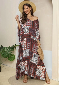 Detail of bohemian floral print kaftan dress with V-neck and split hem for beach vacation