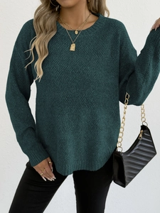 Detail showing deep green long sleeve round neck sweater with gold layered necklace accessory