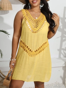 Detail of yellow crochet patchwork knit on a bohemian V-neck beach cover-up dress