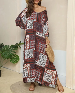 Detail of bohemian print maxi dress featuring intricate patchwork and loose kimono sleeves